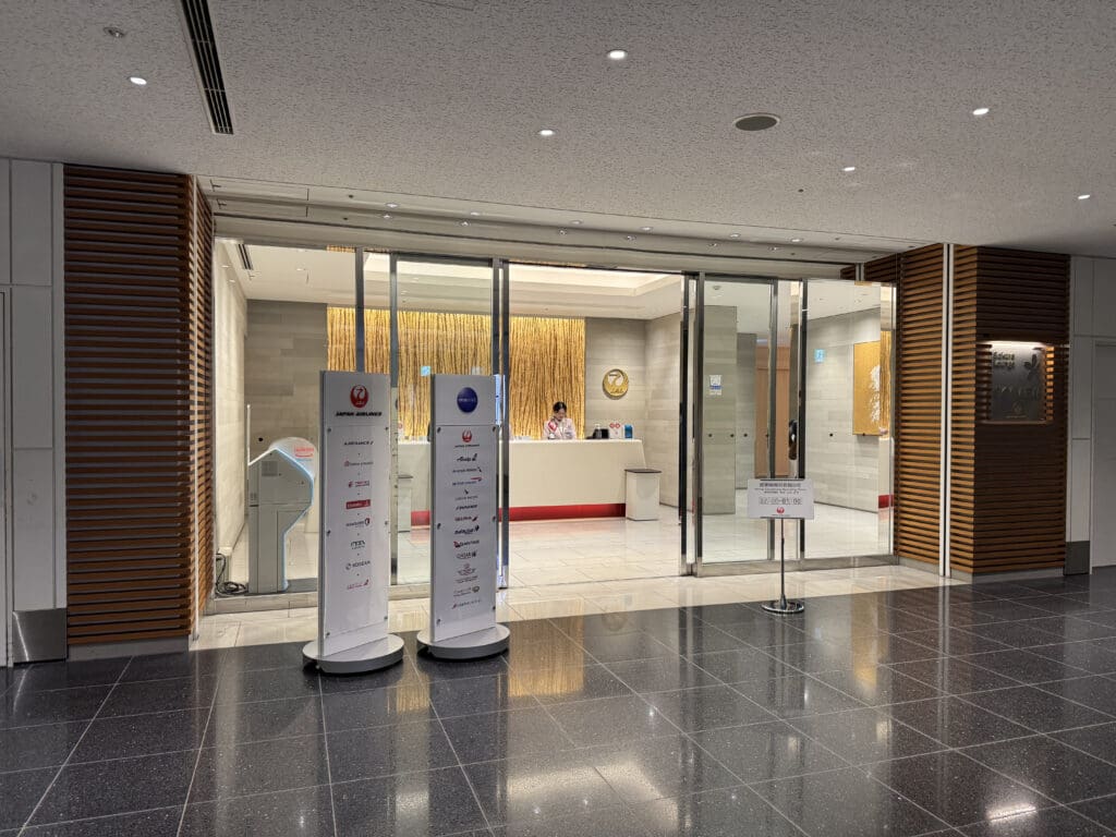 a lobby with glass doors and signs