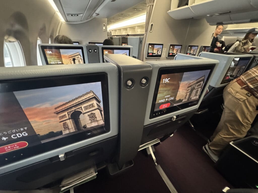 a row of monitors on an airplane