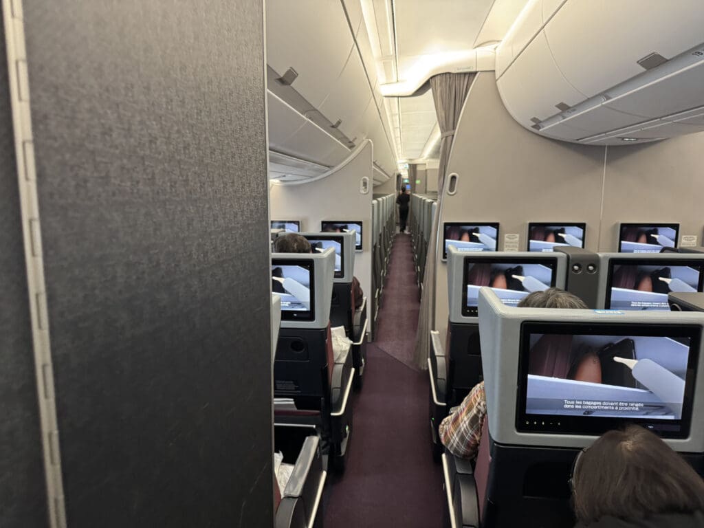 a row of seats with monitors on the side