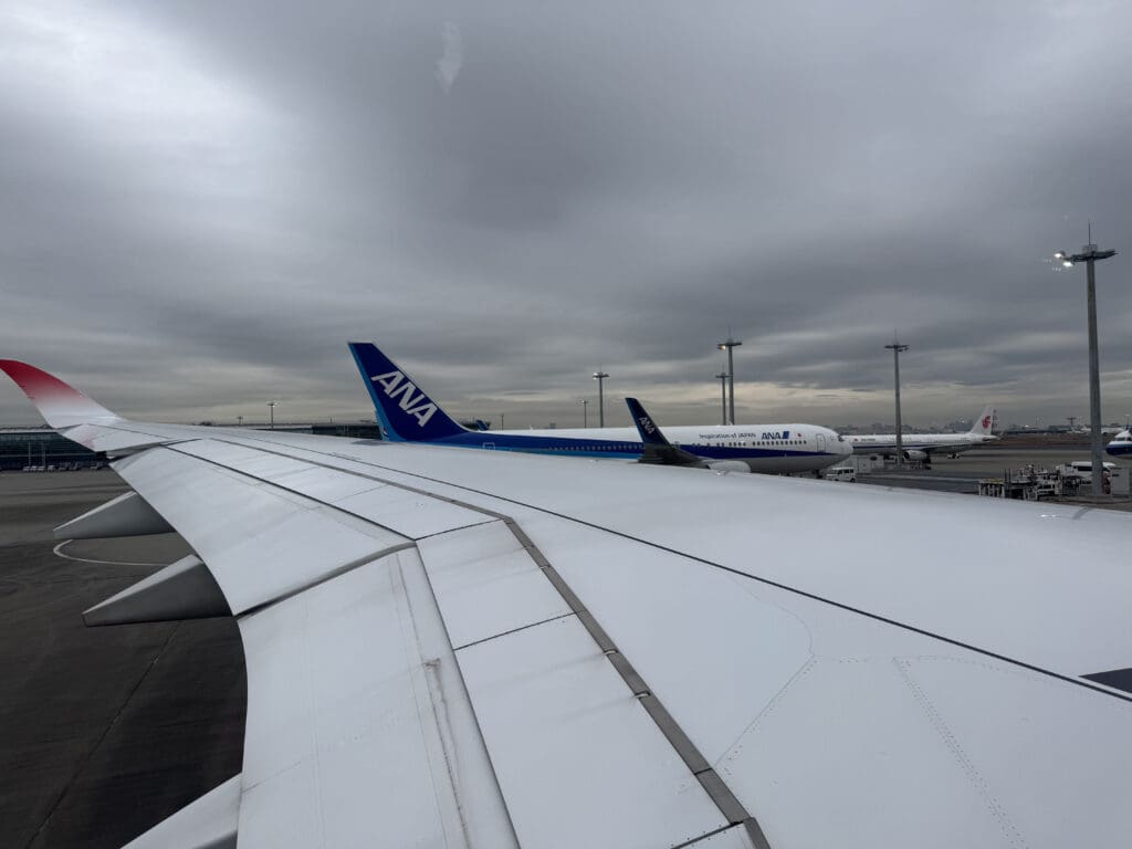 an airplane wing and a few airplanes