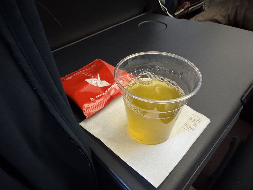 a plastic cup with a drink on a napkin