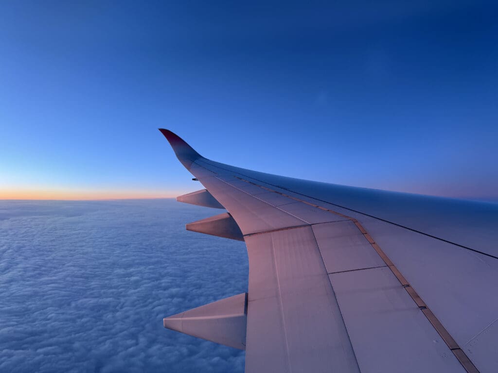 an airplane wing in the sky