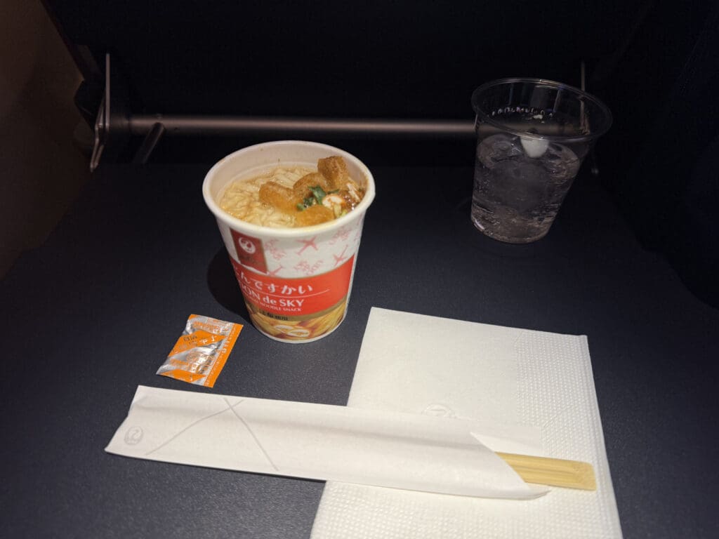 a cup of soup and a glass of water