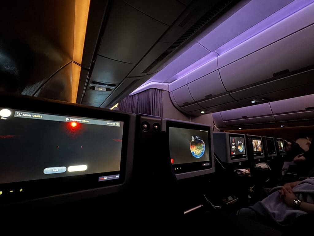 a row of monitors in an airplane