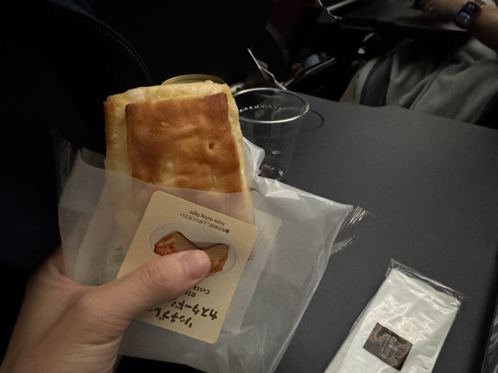 a hand holding a bag of bread