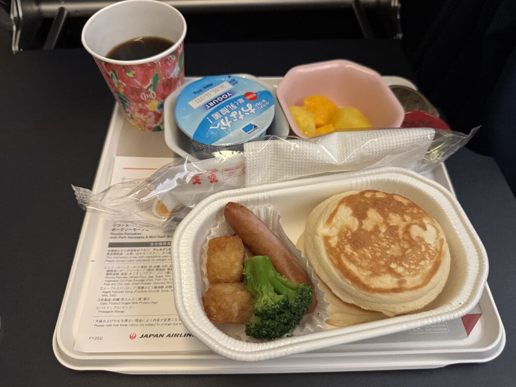 a tray of food and a cup of coffee