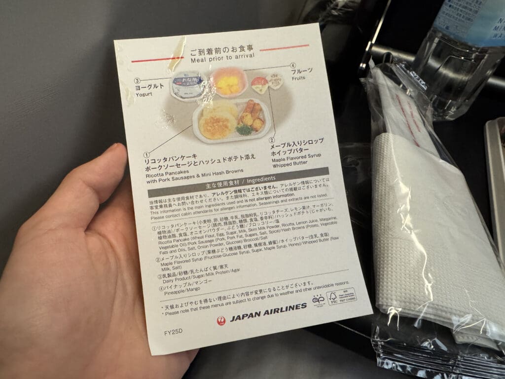 a hand holding a paper with text