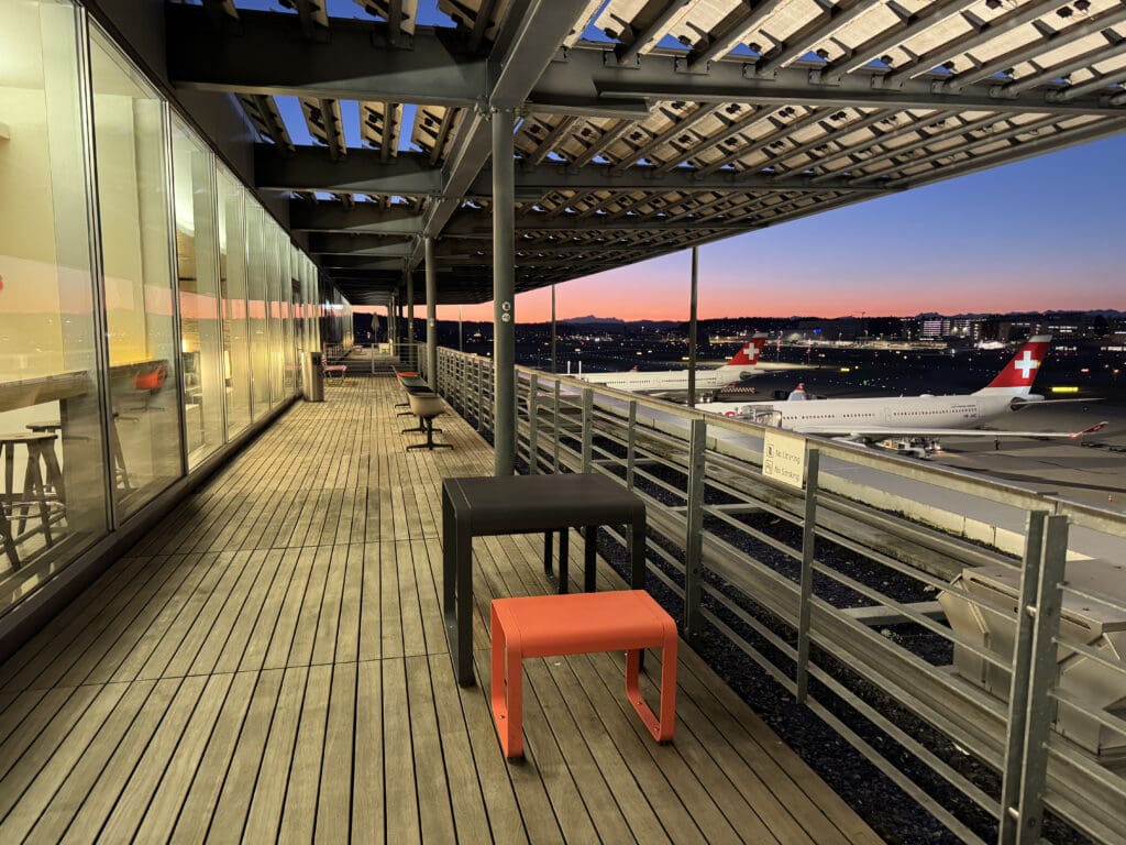 a deck with a table and chairs on it