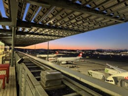 an airport with a train track and airplanes