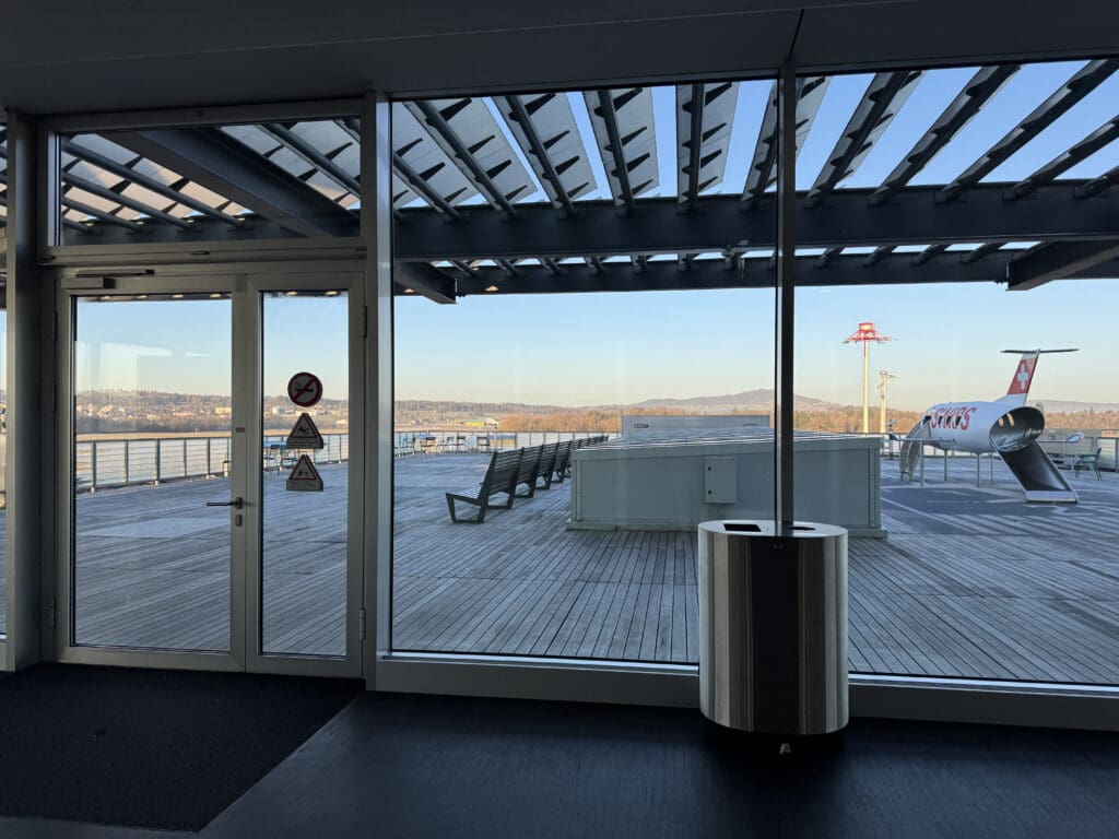 a glass doors with a view of the water and a pier