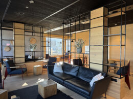 a room with a couch and chairs