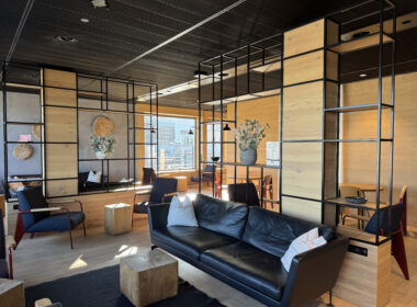 a room with a couch and chairs