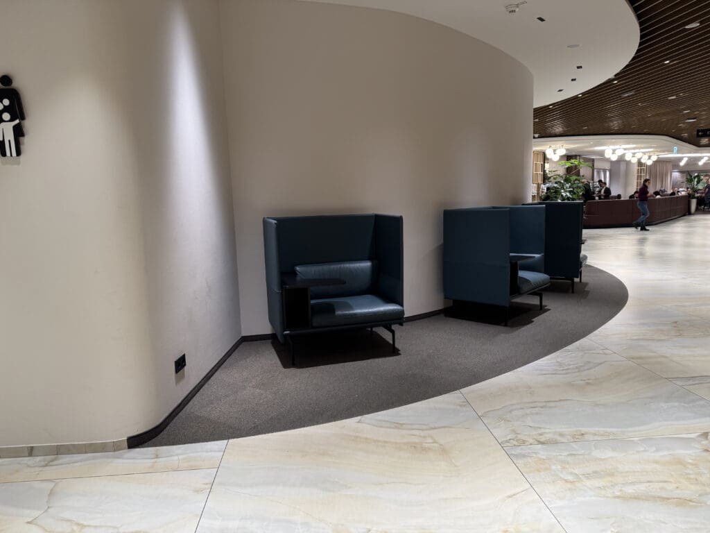 a room with blue chairs and a white wall