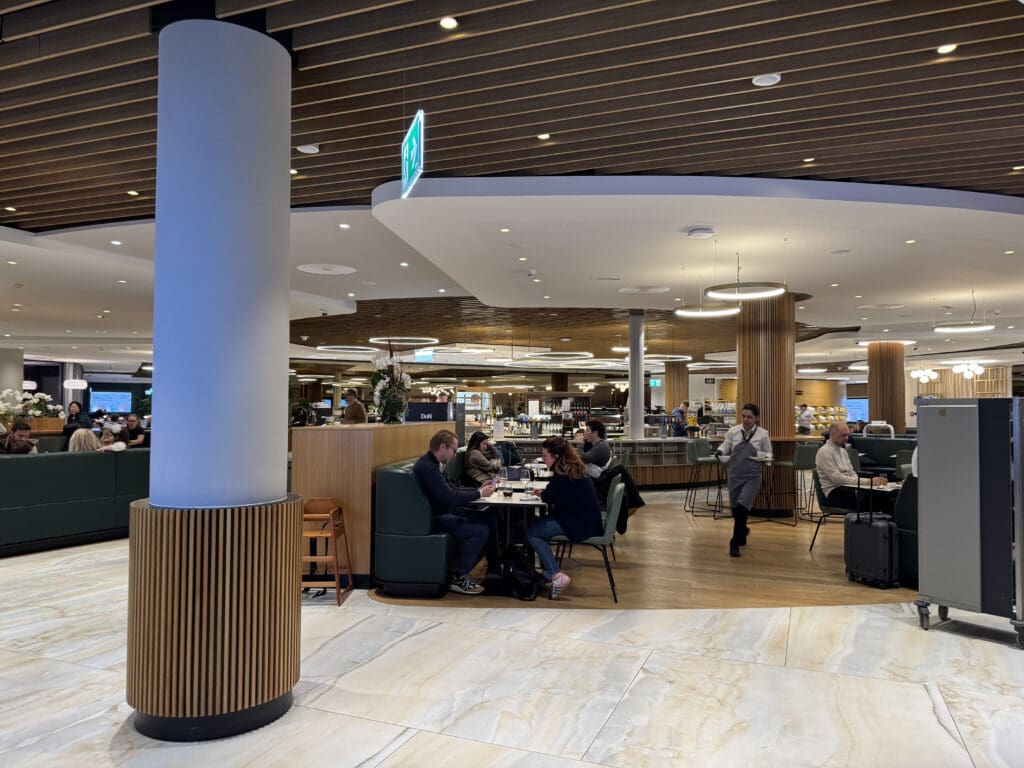 people sitting at tables in a large room