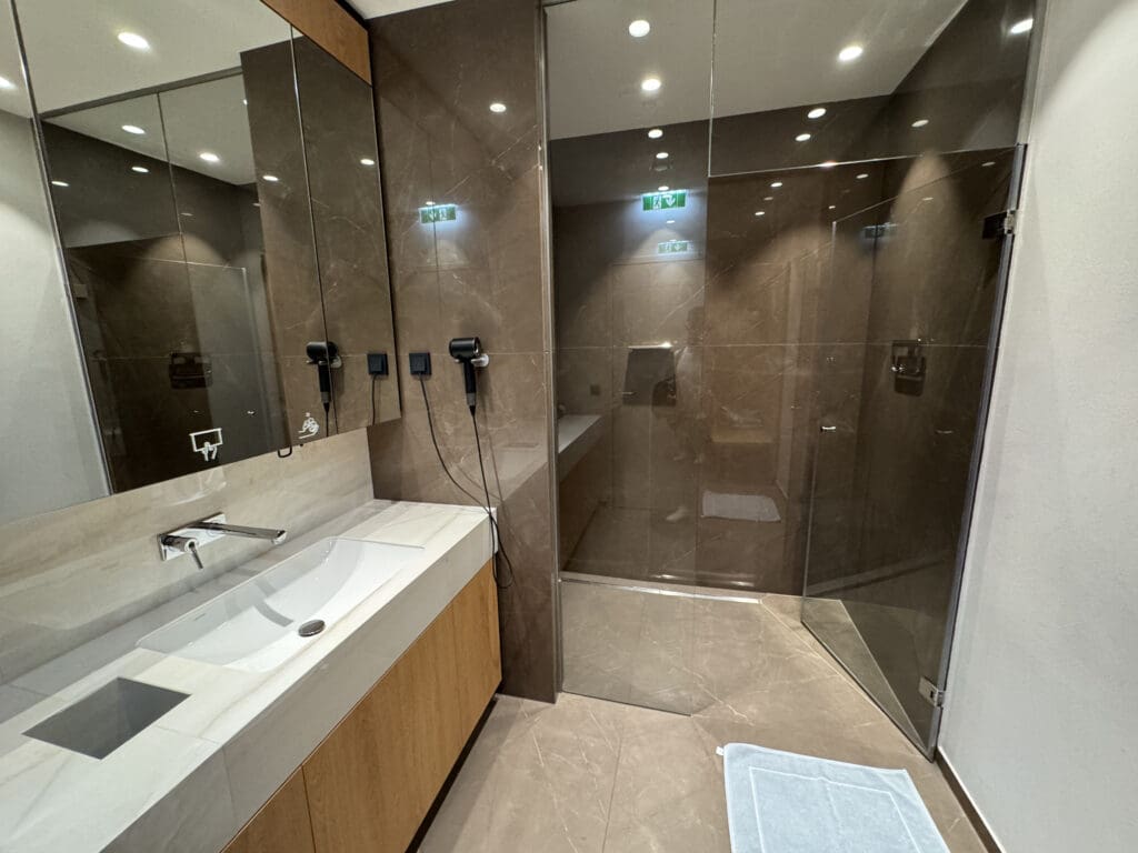 a bathroom with a glass shower and sink