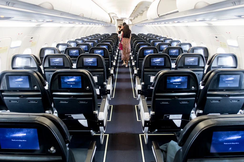 a group of people walking in an airplane