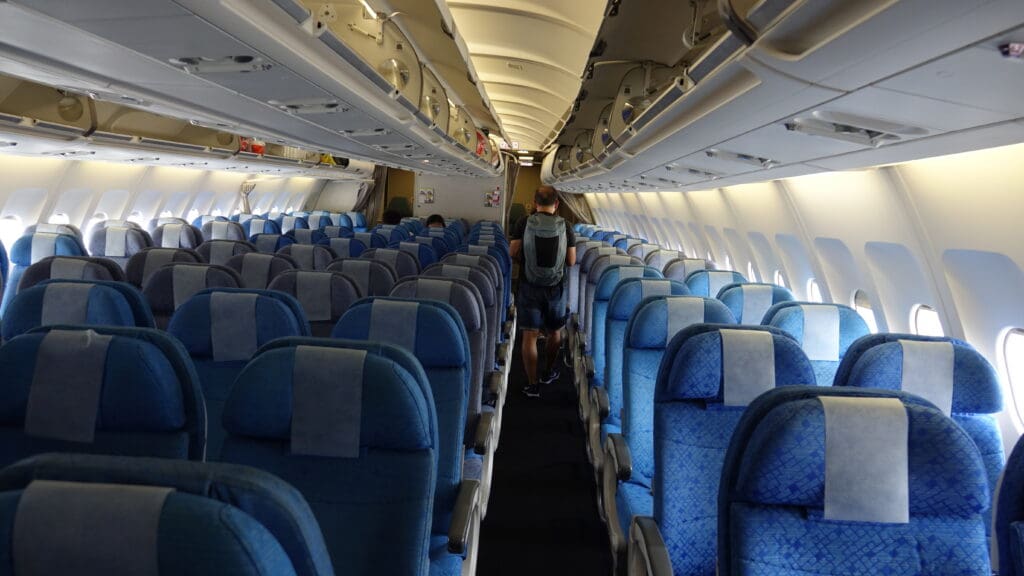 a man walking in an airplane