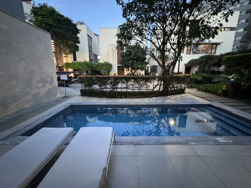 a pool with trees and buildings around it