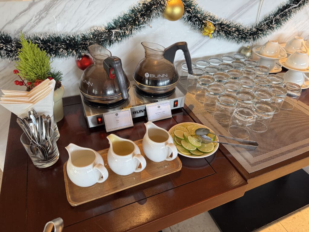 a table with a tray of glasses and a tray of tea