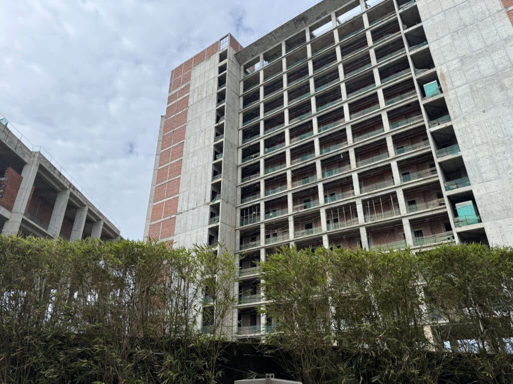 a building under construction with trees