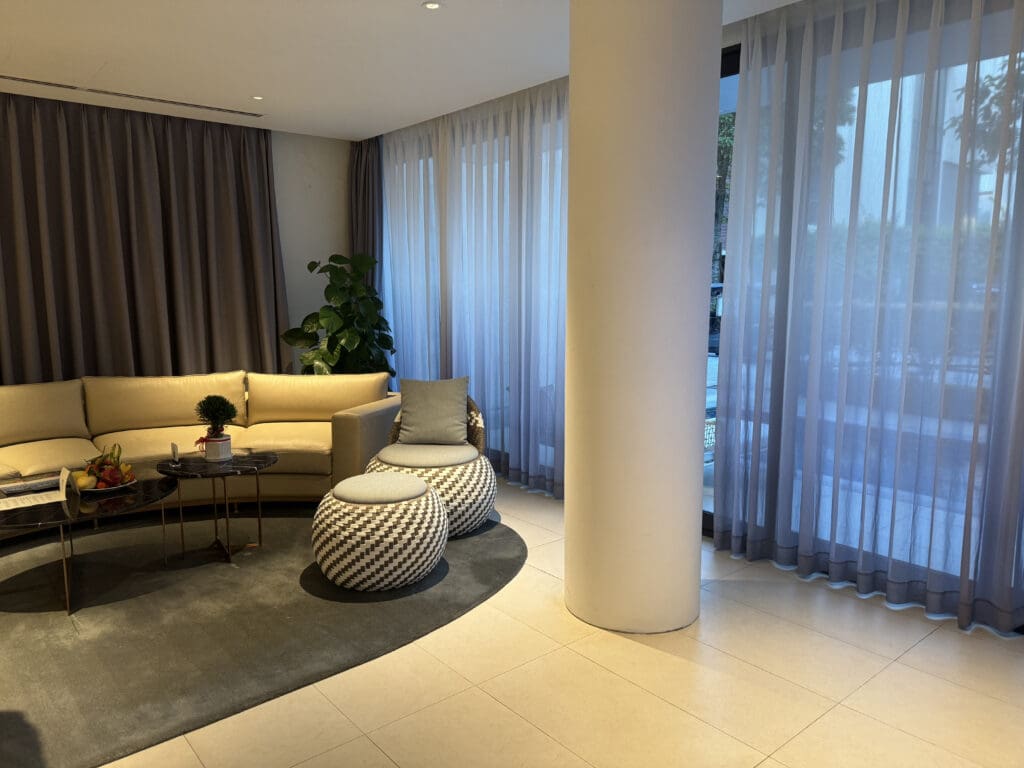 a room with a large pillar and couches