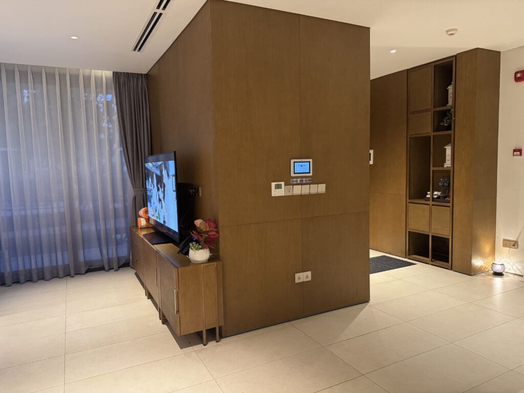a room with a tv and shelves