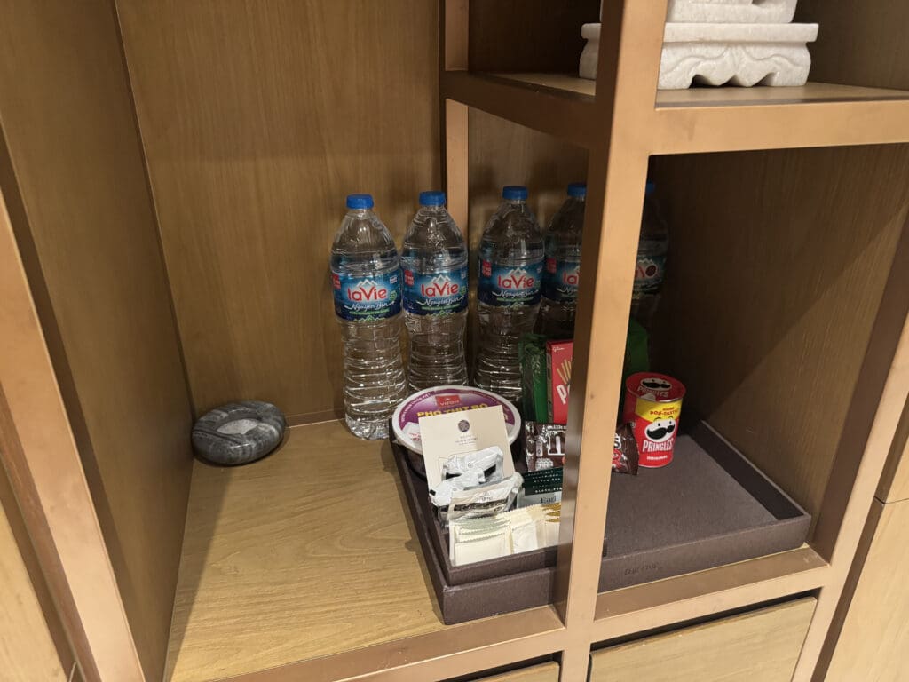a shelf with a group of water bottles and other items