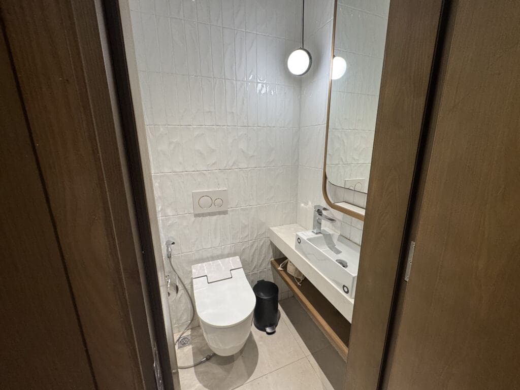 a bathroom with a mirror and toilet