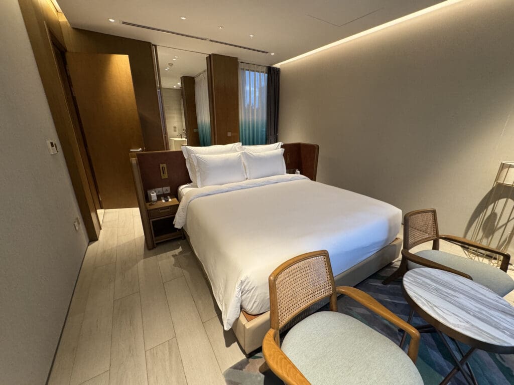 a bed and chairs in a room