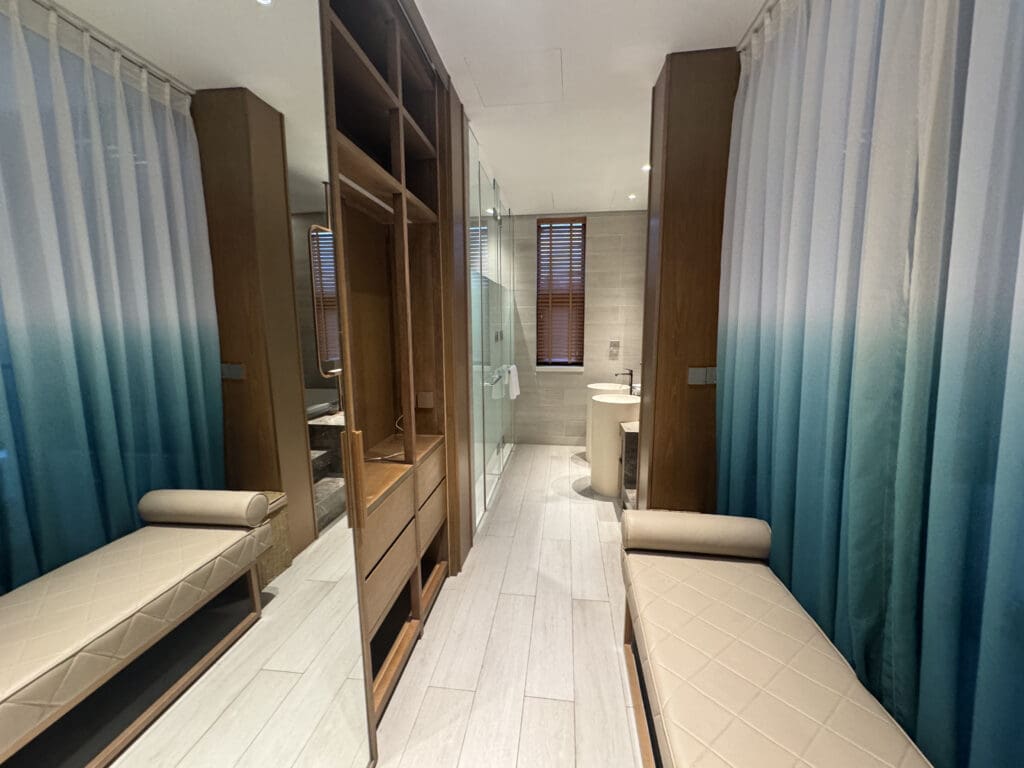 a room with a mirror and bench