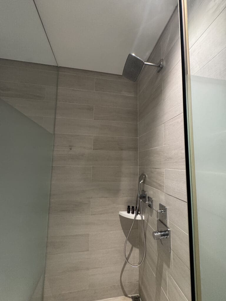 a shower with a shower head and a shower head