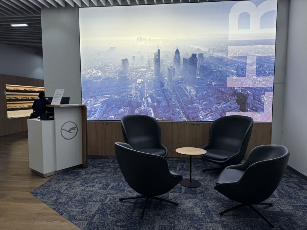 a room with a large screen and chairs