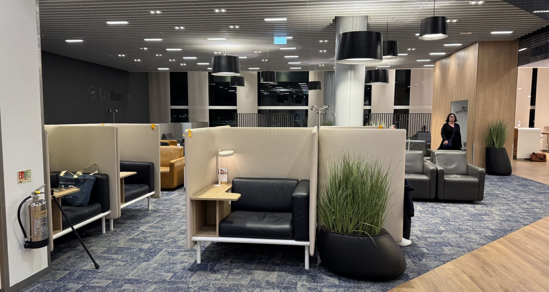 a room with chairs and a woman standing in the background