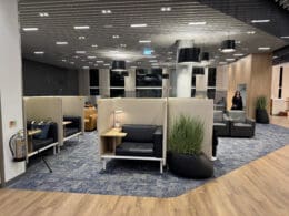 a room with chairs and a woman standing in the background