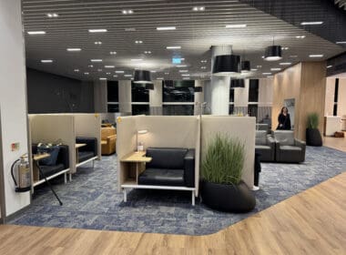 a room with chairs and a woman standing in the background