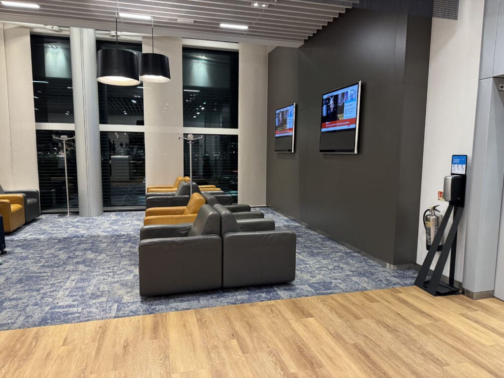 a room with couches and tvs