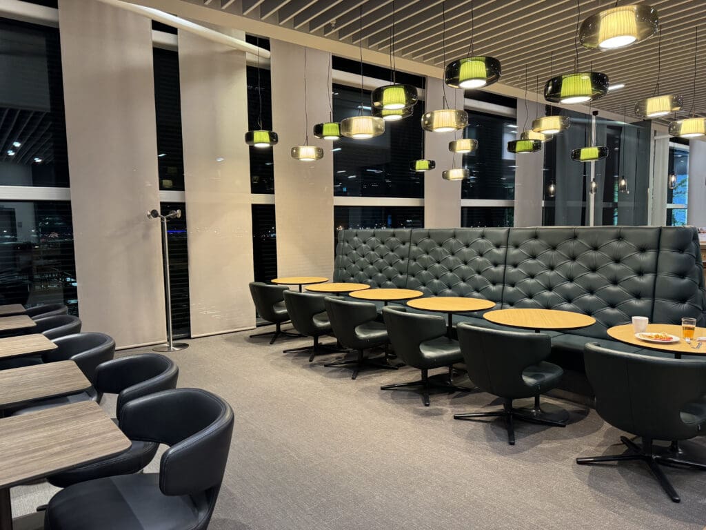 a room with a booth and tables