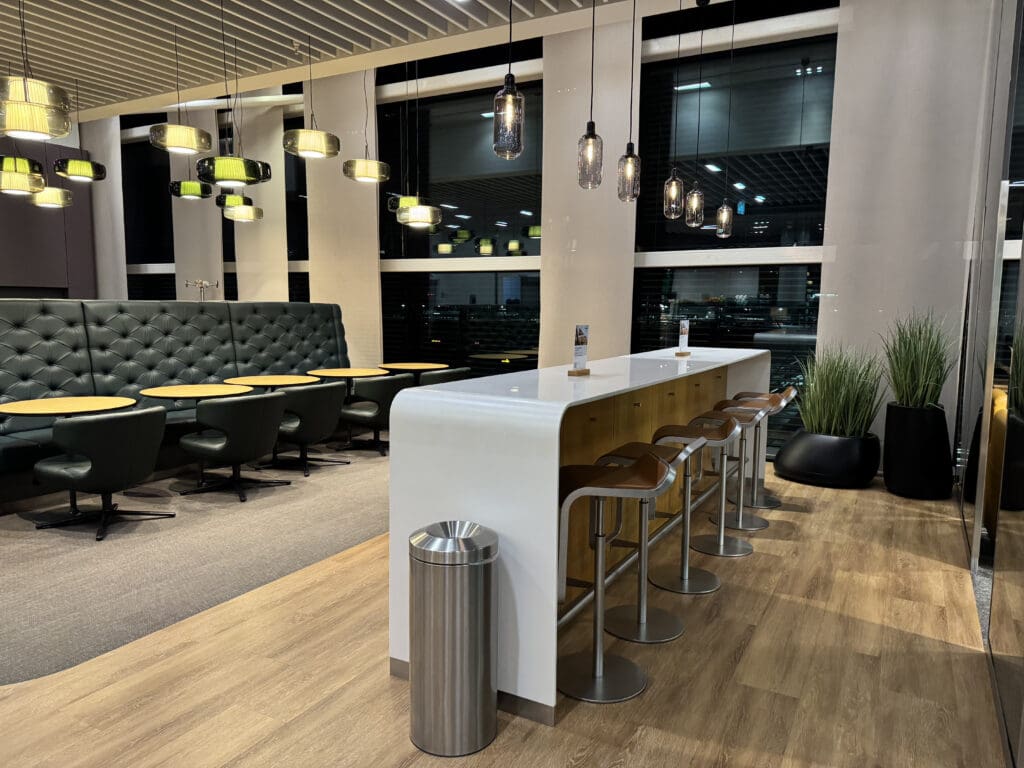 a bar in a room with chairs and tables