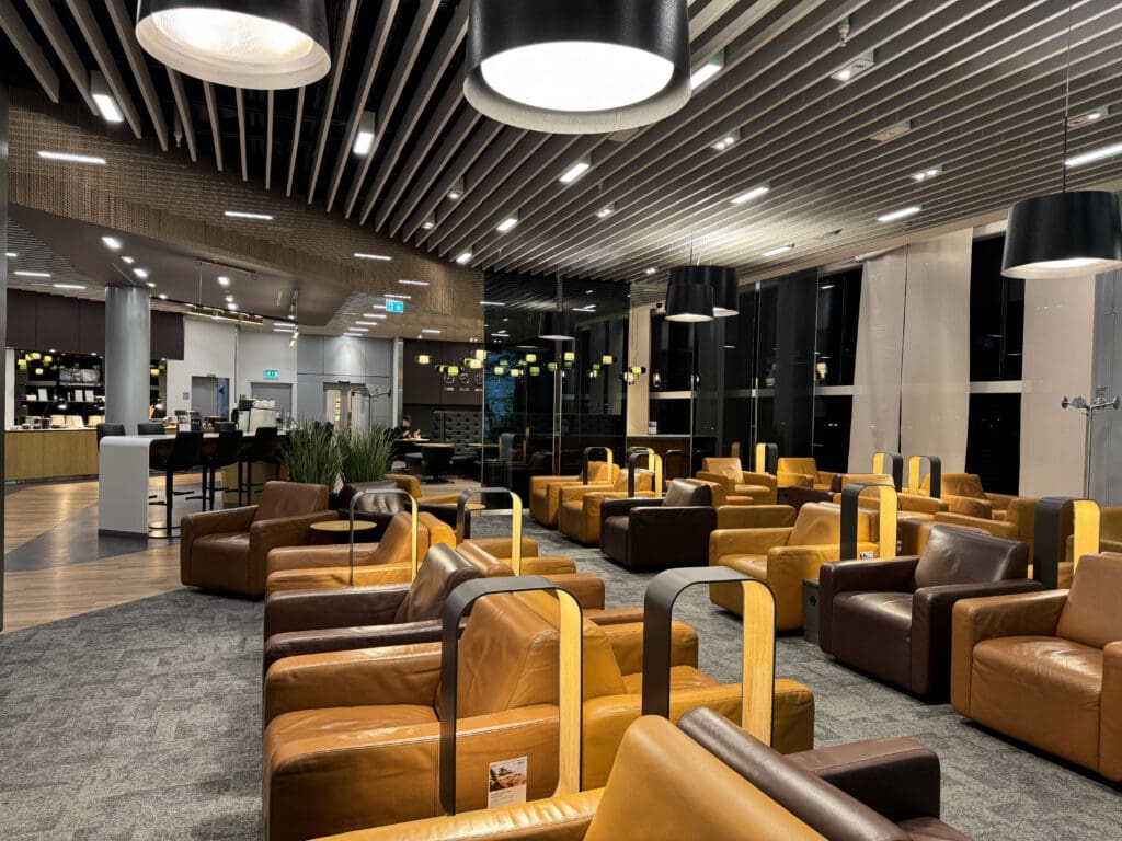 a room with brown leather chairs and a black ceiling