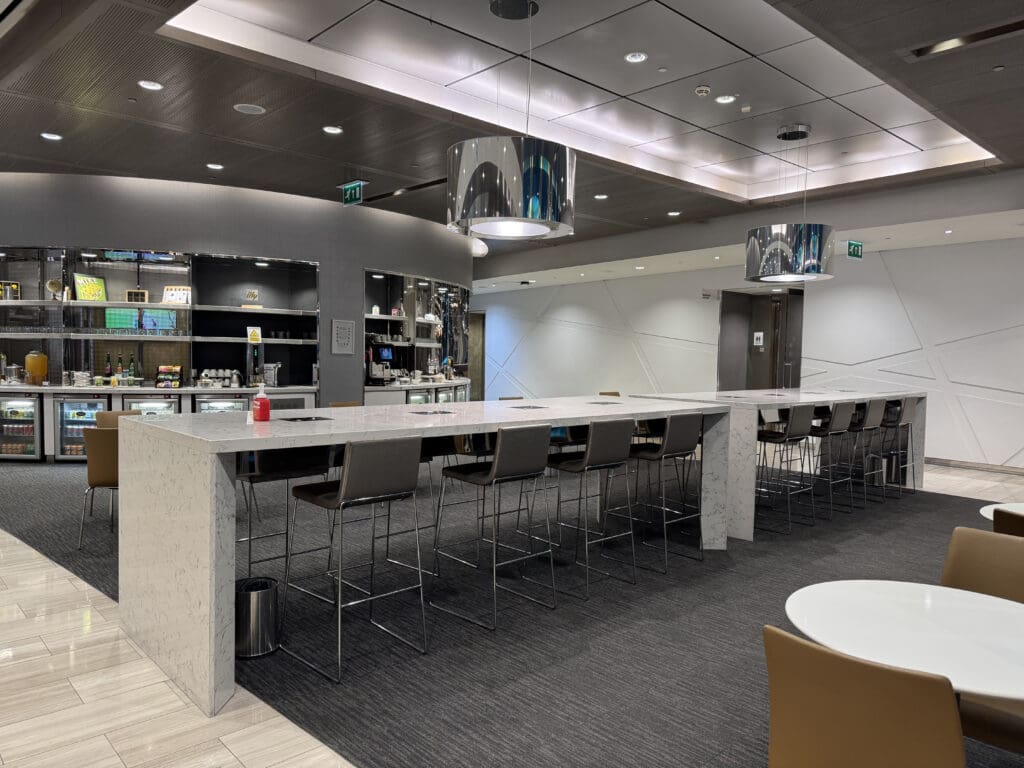 a room with a long counter and chairs