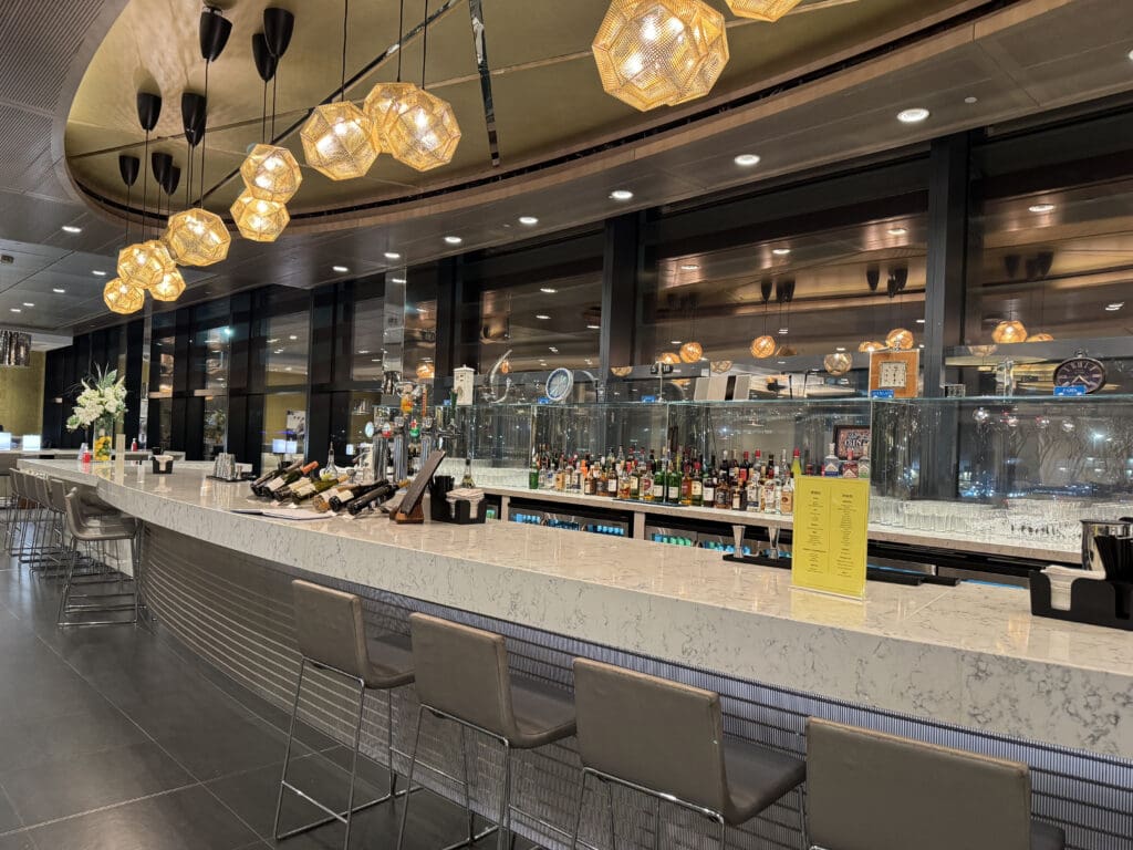 a bar with bottles of wine and lights