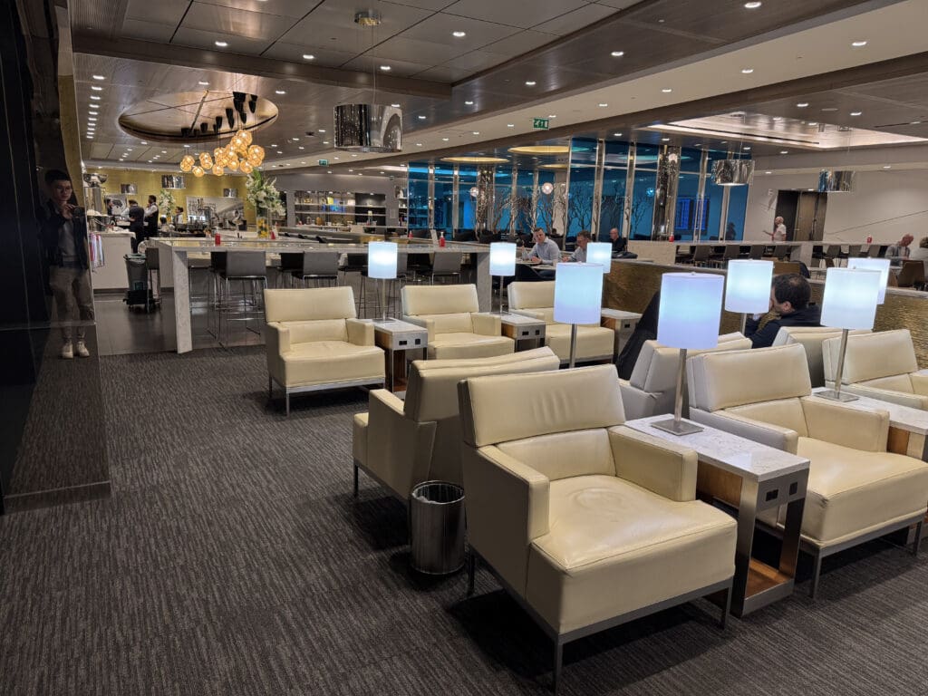 a room with white chairs and tables