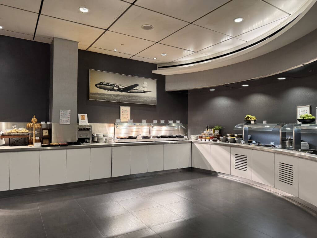 a kitchen with white cabinets and a picture of an airplane