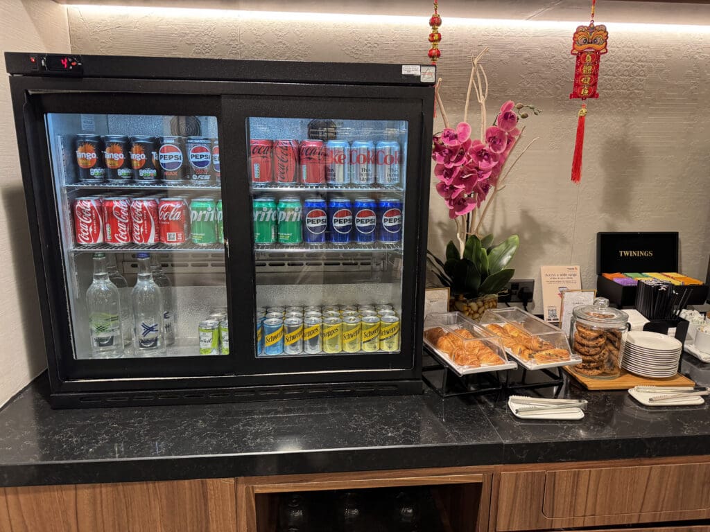 a display case with drinks and snacks