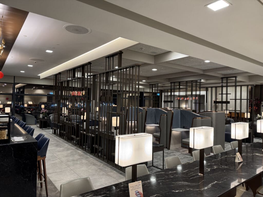 a room with a black marble counter and chairs