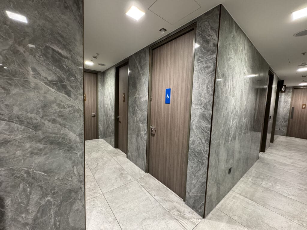 a hallway with doors and marble walls