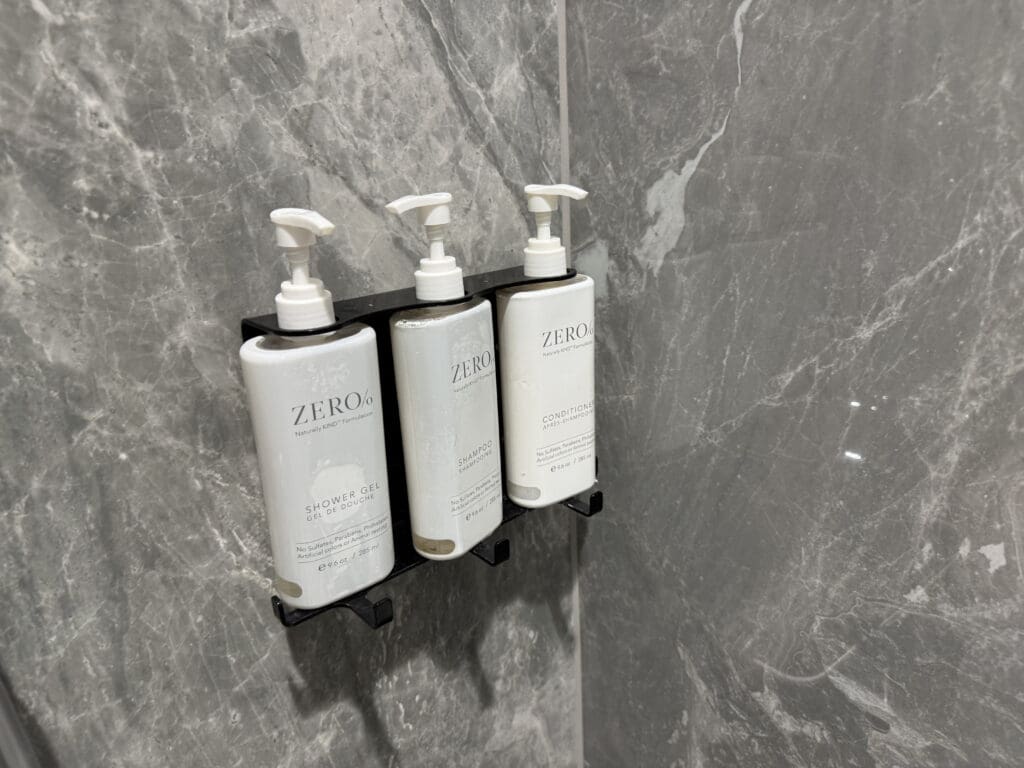 a group of white bottles on a black holder