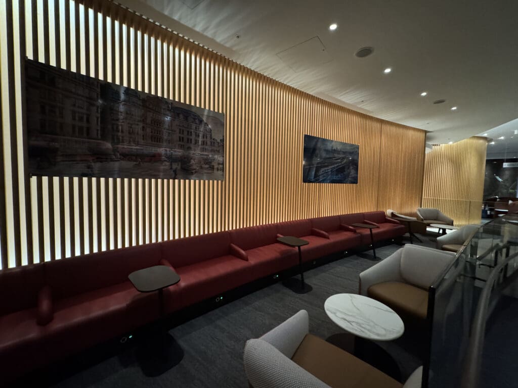 a room with a long couch and tables