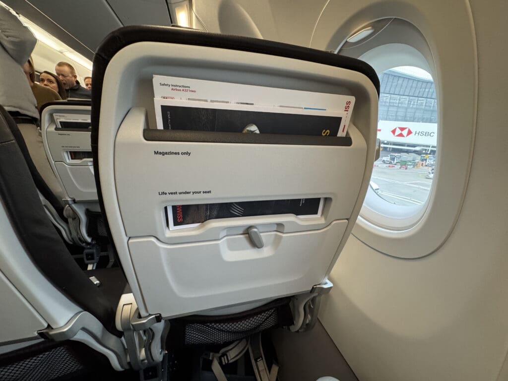 an airplane seat with a magazine in it