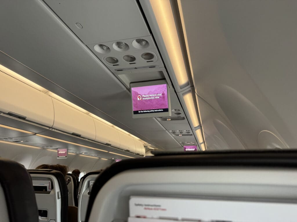a tv on the ceiling of an airplane